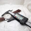 Digital caliper measuring the Swiss Army watch case diameter at precisely 42.0mm.