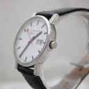 Angled side view of the Mondaine watch, highlighting the polished stainless steel case, the crown, and the clean lines of the design.