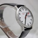 Another angled view from the opposite side, showcasing the minimalist aesthetic and how the black leather strap connects to the lugs.