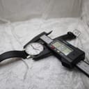 A digital caliper measuring the watch's case diameter, with the display clearly showing a precise measurement of 35.0 mm.