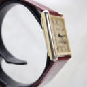 Angled side view of the Corteal watch highlighting the rectangular gold-tone case and acrylic crystal.