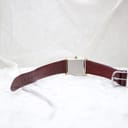 View of the Corteal watch from the rear, showing the stainless steel case back and the full length of the burgundy leather strap.