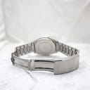 Rear view of the integrated stainless steel bracelet and unsigned fold-over clasp, with the watch case visible in the background.