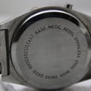 Close-up of the stainless steel case back, clearly showing "waterresistant base metal bezel stainless steel back swiss" engraving.