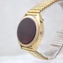 Side profile view of the gold-tone Chronex LED watch, showcasing the oval display and the two control pushers on the right side of the case.