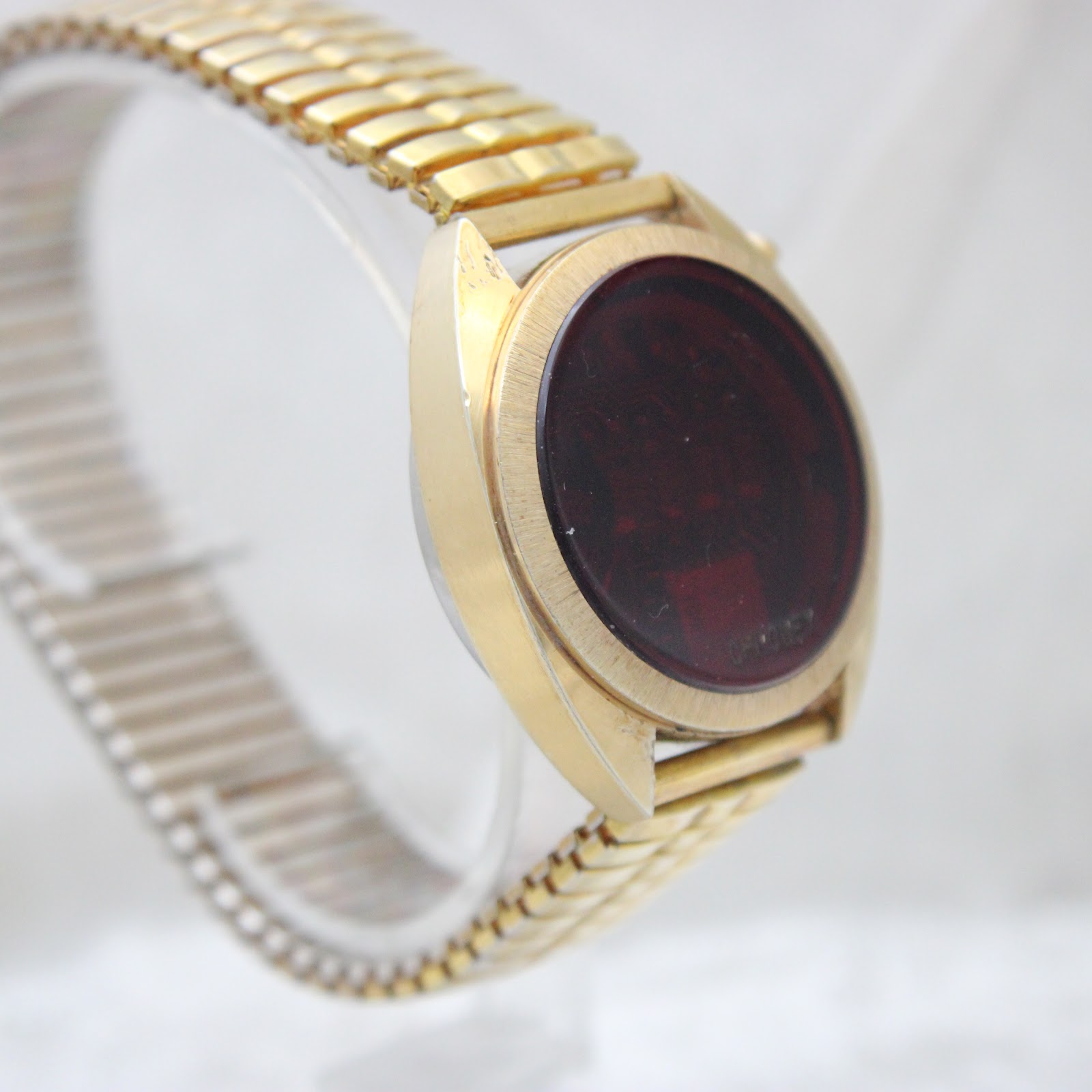 Three-quarter view of the Chronex LED watch, highlighting the brushed texture of the gold-tone case and the segmented expansion bracelet.