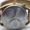 Macro shot of the Chronex watch's stainless steel case back, engraved with "BASE METAL BEZEL STAINLESS BACK", "U.S.A.", and serial number "74578".