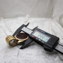 Digital caliper measuring the case diameter of the Chronex watch, with the display clearly reading "34.4 mm".