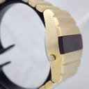 Opposite side profile view of the watch, showing the uninterrupted lines of the integrated gold-plated bracelet and the case's brushed texture.