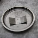 Close-up of the detached stainless steel case back, clearly engraved with 'LA GENERALE SWISS MADE' and the brand's arrow logo.