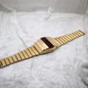 Full-length, slightly angled view of the La Générale LED watch, highlighting the continuous design of the gold-plated integrated bracelet and case.