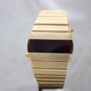 Front-on view of the gold-plated La Générale LED watch with its blank, dark red digital display, presented on a white background.