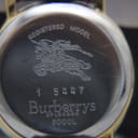 Close-up of the stainless steel case back engraving, showing "Burberrys of London 6000L" and registered model number.