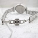 Close-up view of the stainless steel butterfly clasp on the Escada Lauren watch bracelet, opened flat on white fabric.