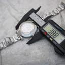 Digital caliper measuring the case diameter of the Escada Lauren watch, displaying a precise measurement of 38.8 mm.