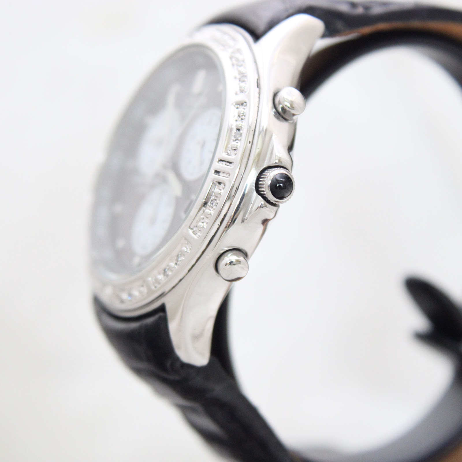 Side view of the Citizen Eco-Drive watch showing the crown and pushers, and polished case.