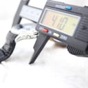 Digital caliper measuring the watch case diameter at 41.0 mm.