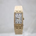 Front view of the rectangular gold-plated Bulova ladies watch with silver dial and integrated textured bracelet.
