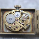 Close-up view of the Swiss made Bulova 17-jewel manual wind movement (cal. 1000.11) with visible gears and jewels.