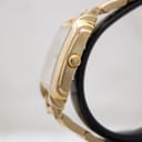 Side profile of Raymond Weil gold-tone rectangular case and fluted crown.
