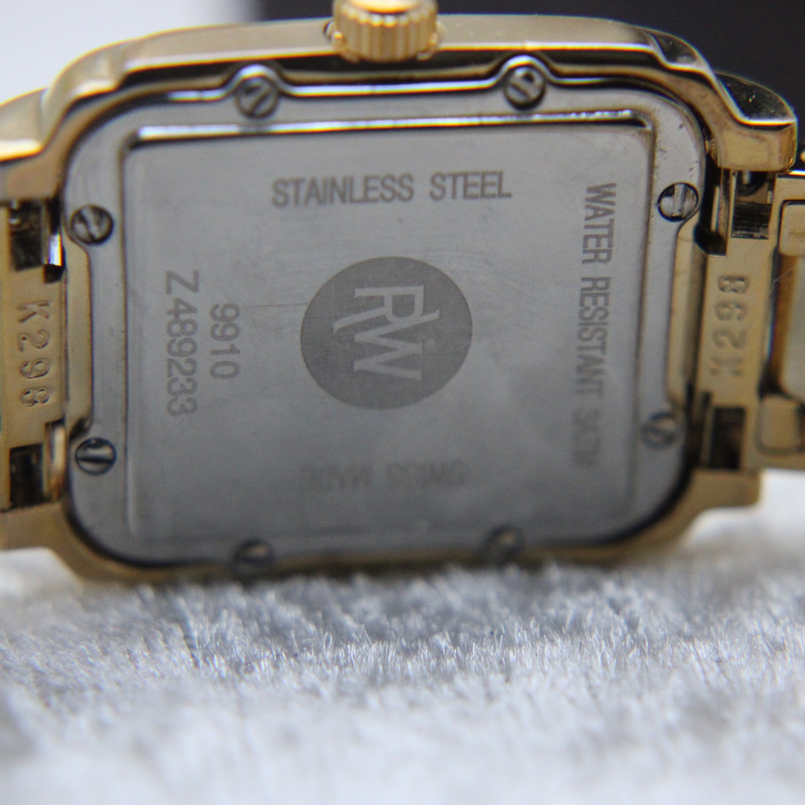 Detailed view of Raymond Weil Saxo watch dial with Roman numerals and date window at 6 o'clock.