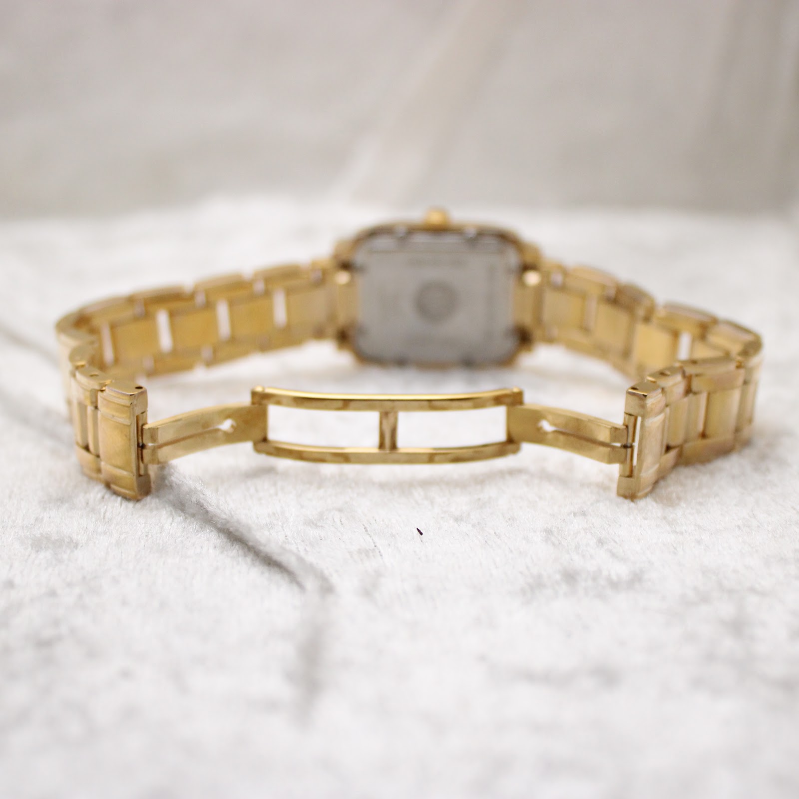 Raymond Weil Saxo 9910 watch showcasing its elegant gold-tone design and bracelet.