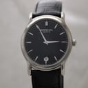 Front view of Raymond Weil Genève 5571 watch with black dial, silver hands and indices, on a black leather strap.