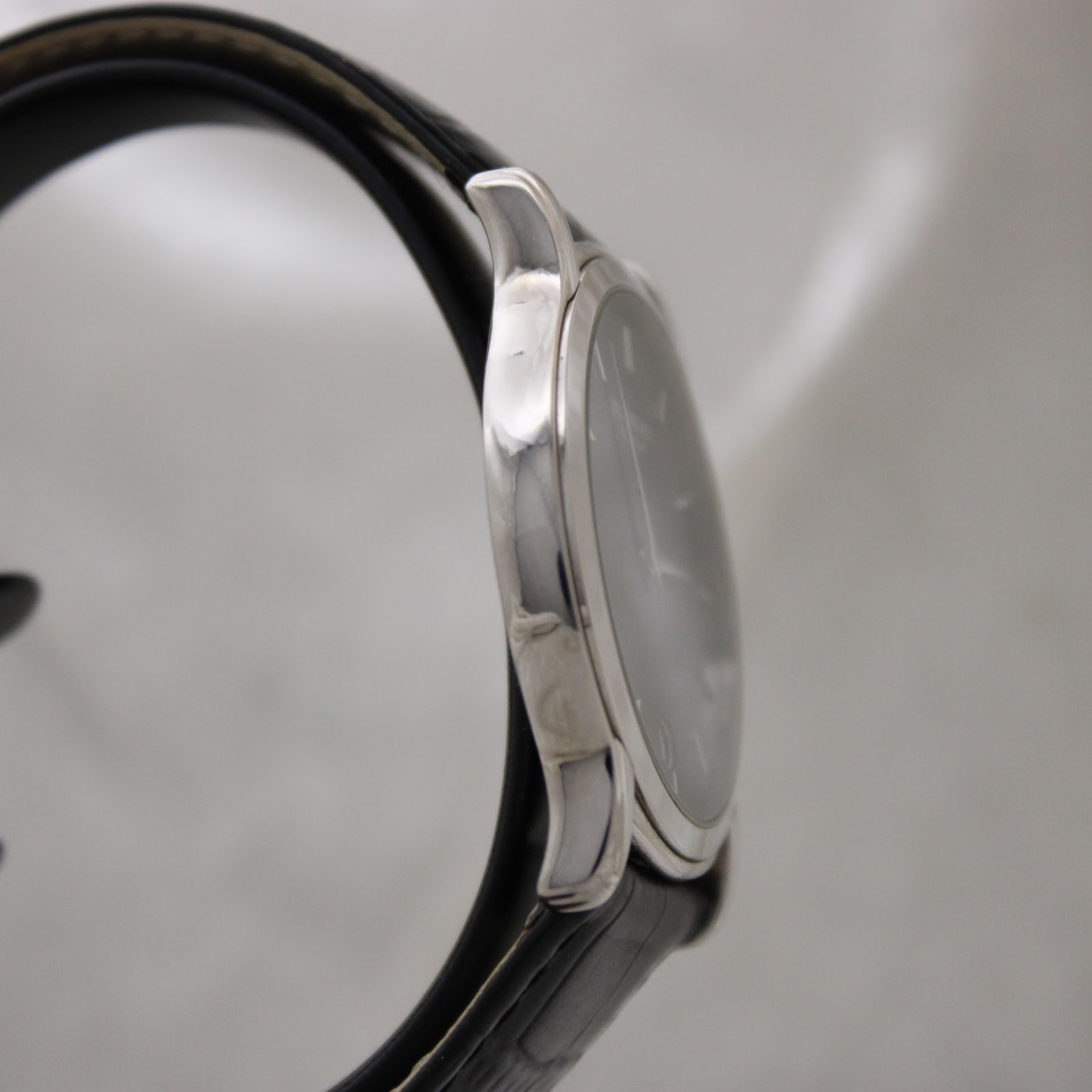 Another side profile view of the polished stainless steel case and crown of the Raymond Weil 5571 watch.