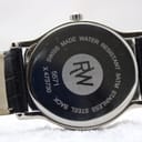 Close-up of the polished stainless steel case back with "Swiss Made Water Resistant 3ATM Stainless Steel Back" and serial number X473730.