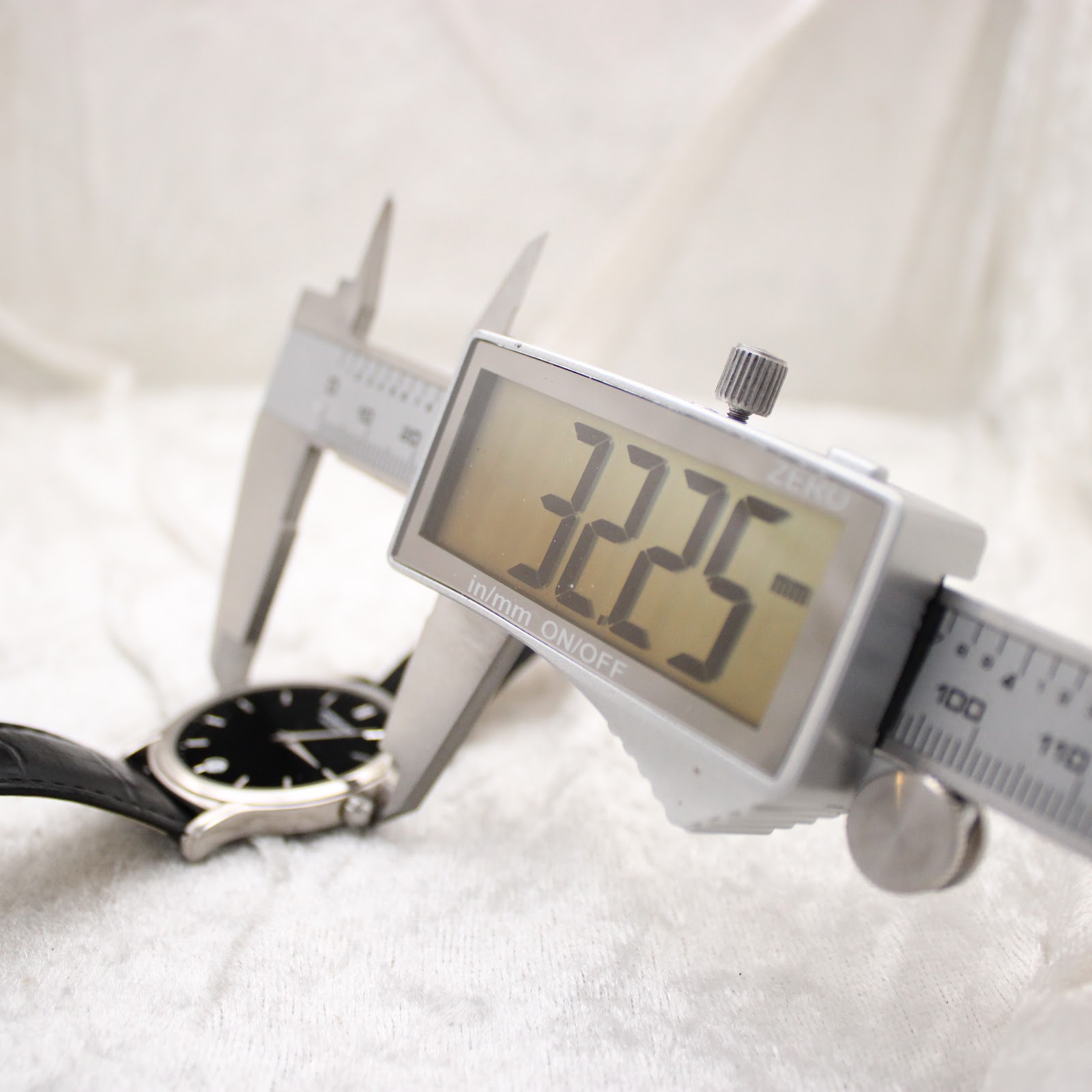 Digital caliper measuring the watch case diameter at 32.25mm.