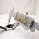 Digital caliper measuring the watch case diameter at 32.25mm.