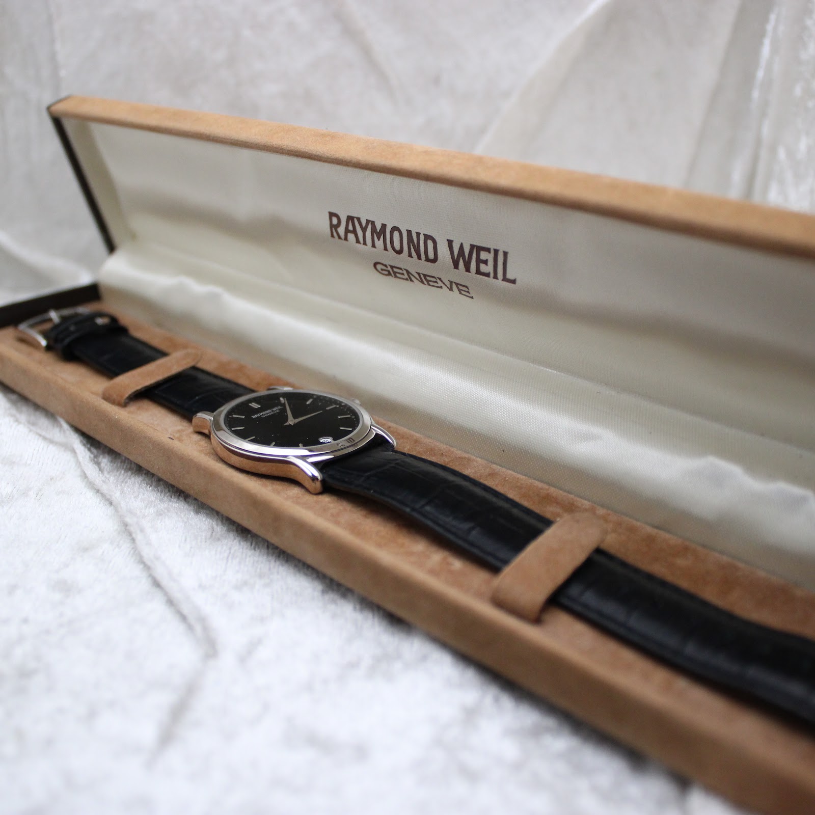 The Raymond Weil 5571 watch resting inside its original presentation box.