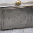 Close-up of the stainless steel case back of the Raymond Weil Tango, showing 'Water Resistant 5ATM', 'Swiss Made', 'Sapphire Crystal', 'RW' logo, model '5970', and serial 'K008596'.