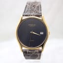 Front view of the gold Raymond Weil watch with a black striped dial and date window, presented on a white background.