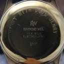 Close-up of the watch case back showing an engraved personal message 'Barry with love Jenny' and 'Raymond Weil 18K Gold Electroplated 5501'.
