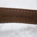 Detailed shot of the strap's underside, showing the embossed 'CROCO VERITABLE' text, indicating genuine crocodile leather.