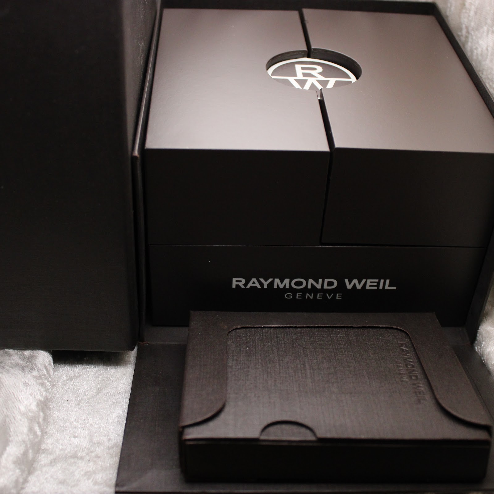 Opened Raymond Weil outer box, revealing the inner presentation box and a sleeve for documentation