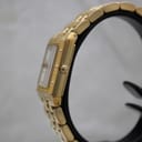 Side profile view of the gold Raymond Weil Tango watch case and link bracelet on a stand