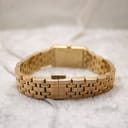 Rear view of the gold watch bracelet with the fold-over deployant clasp mechanism