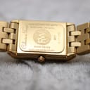 Detailed view of the gold watch case back, showing 'Raymond Weil Genève', 'Tango Collection', 'Gold Electroplated 10µm', 'Sapphire Crystal', 'Swiss Made', 'Water Resistant 5ATM', '5971', and serial number 'K171355'
