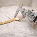 Digital caliper measuring the watch case, displaying a precise diameter of 24.63mm.