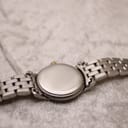 View of the solid stainless steel case back and the two-tone bracelet resting on a soft surface.