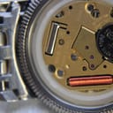 Close-up of the open watch case, revealing the Tissot quartz movement with 'ETA F03 111 THREE 3 JEWELS' visible.