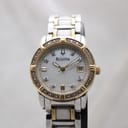 Front view of Bulova two-tone quartz watch with white mother-of-pearl dial and crystal-set bezel.
