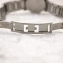 Close-up of the stainless steel folding clasp on the watch bracelet, showing "stainless steel" engraving.