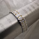 The two-tone bracelet wrapped around a sizing mandrel, showing a wrist size of approximately 17.2 cm.