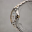 Side view of the Raymond Weil 5377 watch, showing the gold-tone crown and the two-tone bracelet details.