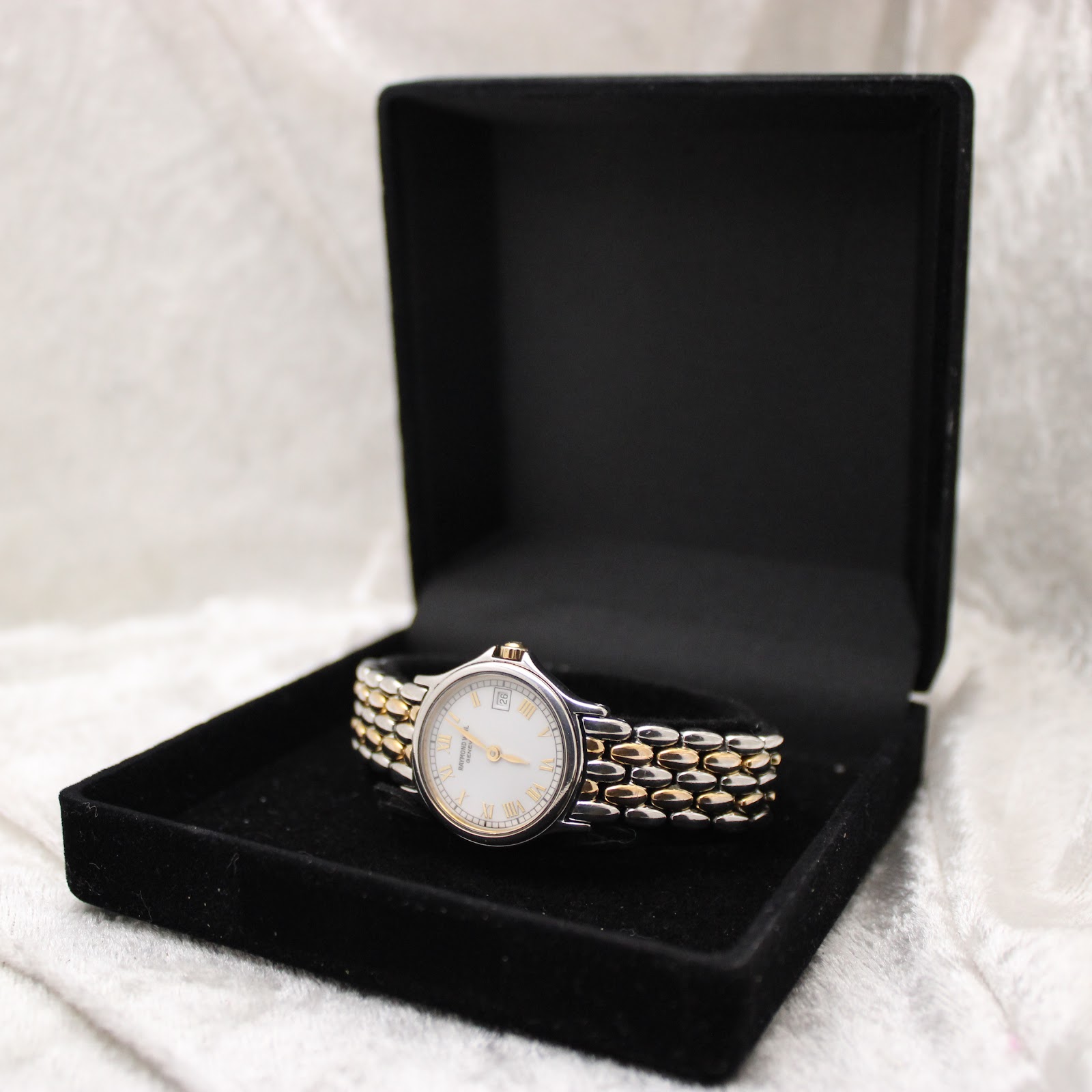 Raymond Weil Genève 5377 watch displayed in an open black watch box, showcasing its elegance.