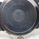 Close-up of the watch case back, engraved with 'stainless steel', 'water resistant 5atm', 'sapphire crystal', and model number 5360.
