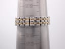 Close-up of the two-tone stainless steel bracelet on a wrist sizing gauge, showing a measurement of 57mm / 17.2cm.